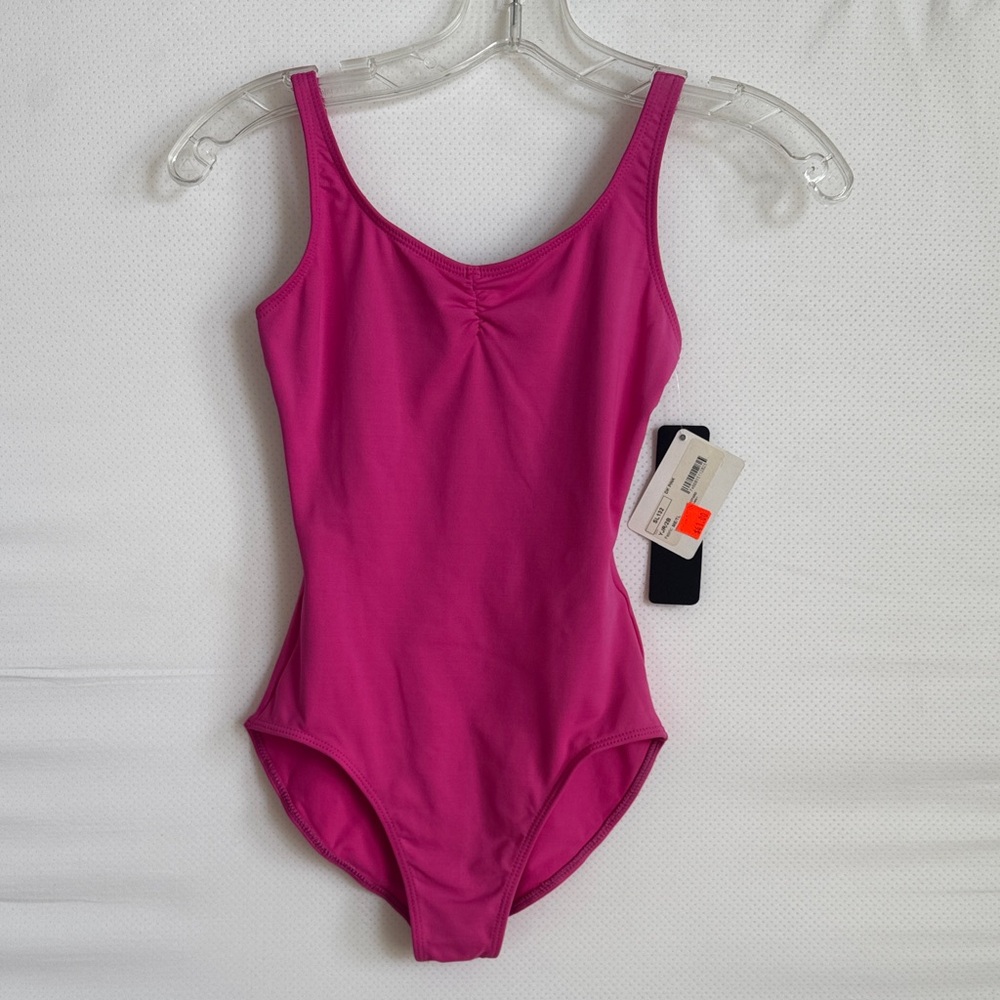 Child tank leotard with pinch front design and mesh back.